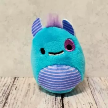 mini squishmallow rorty placed on top of table