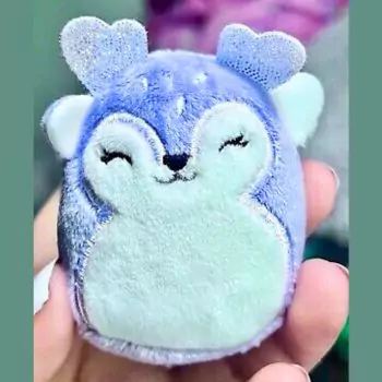 small squishmallow farryn in hand