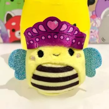 small squishmallow sunny waring hat in front of yellow mystery blind